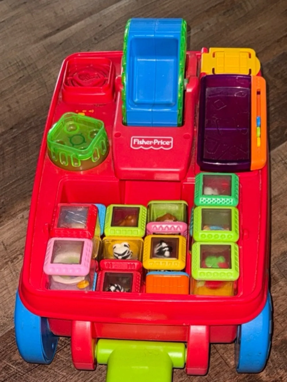 Vintage Fisher-Price Peek-a-boo Pull Toy with Green Handle and Blue Wheels